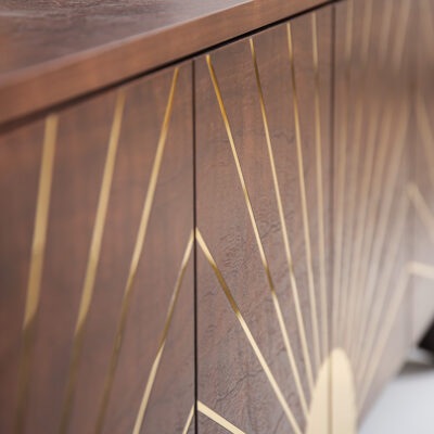 Polished brass inlay detail on the Astor Sideboard highlighting architectural geometry.