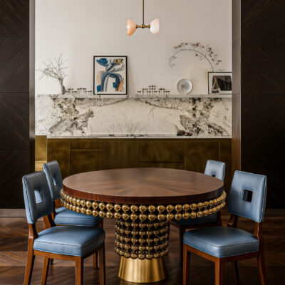 Modern luxury dining table with ebony wood surface and radiant brass sphere base.